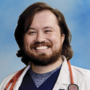 Bryan Boyle headshot in white coat on blue background