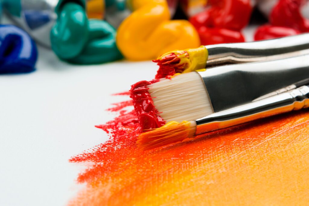 images of orange and yellow paint on a brush 