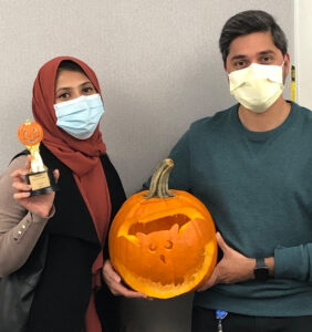 Group of medical residents carving a pumpkin