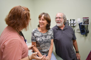 Smiling couple talking to medical provider