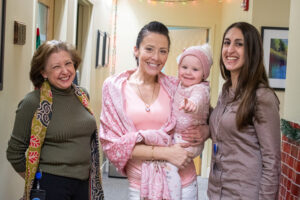 No longer homeless, Jennifer Parker, seen here holding 2-year-old daughter Naudia, receives recovery services and support through the area’s Healthy MOMS program. Maria Kolcharno, at left, director of addiction services at The Wright Center for Community Health, and Vanessa Zurn, far right, a Healthy MOMS case manager at The Wright Center, are among the team members who assist more than 135 actively enrolled women and their children.