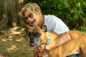 Picture of Michaelene Davis with her boxer Rosie