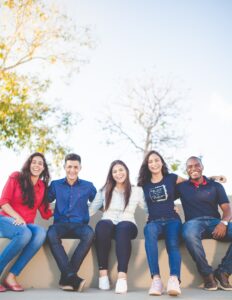 Image of a diverse group of people sitting on a wall