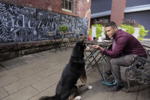 Dr. Kevin Beltré and his Siberian husky named Genji enjoy a stop at a popular downtown Scranton coffee shop, one of the places the resident physician finds especially appealing in the community. 