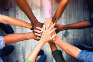 group of people hands together in a circle