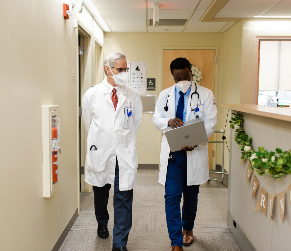 Dr. Edward Dzielak walking with medical resident