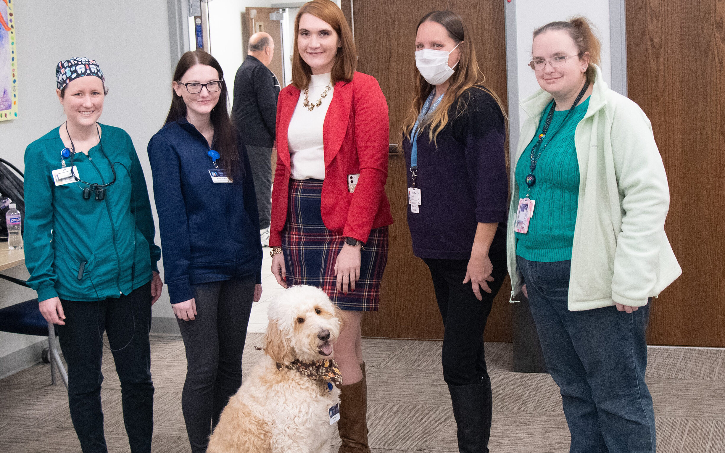 Group of TWC employees with Sadie, the wellness dog