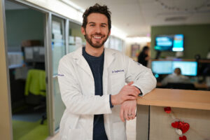 Dr. Stephen Long's smiling portrait with white coat in Mid Valley practice