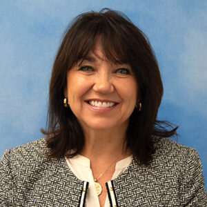 teri's smiling headshot with dark hair and bangs