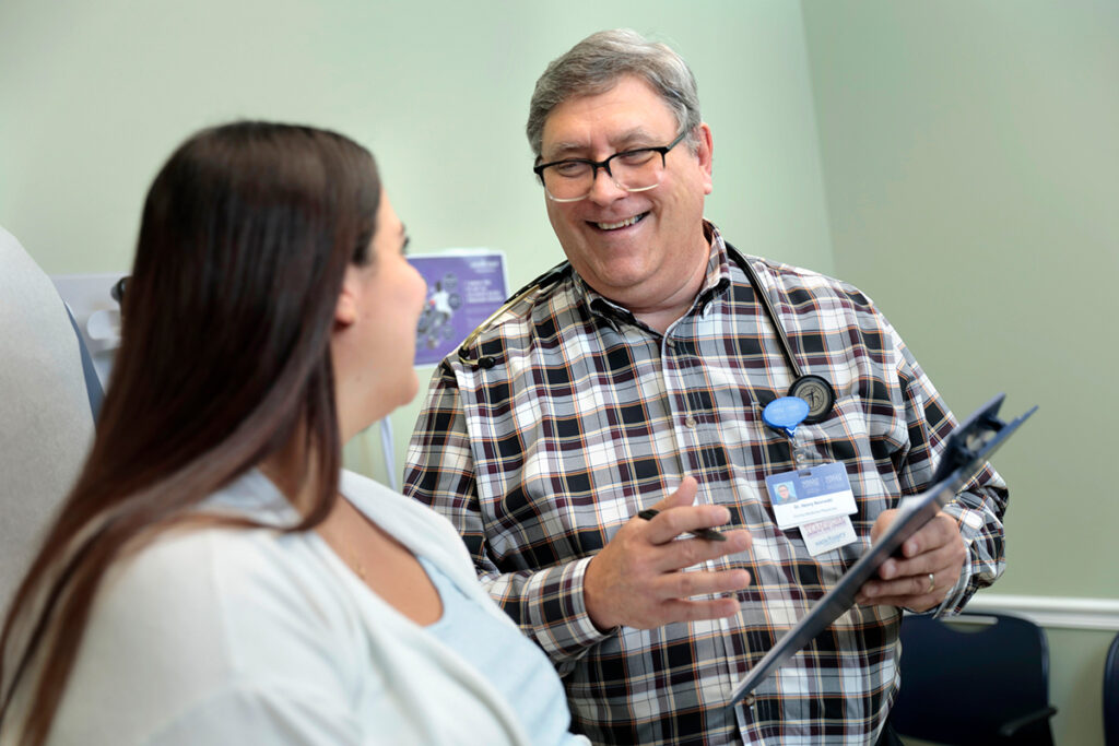 Smiling doctor talking to patient