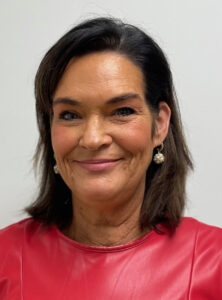 Kara Seitzinger's smiling portrait in a red dress