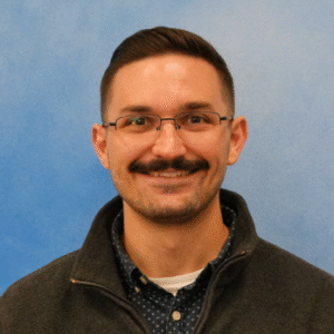 Tyler Wilson's smiling headshot in dark top