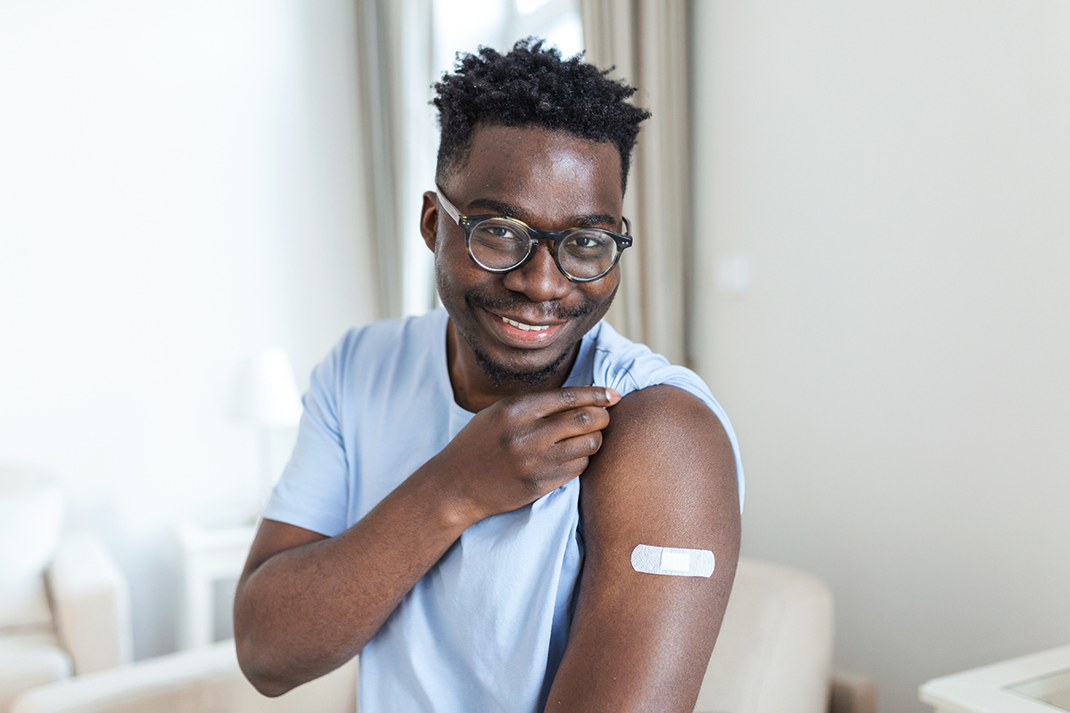 Man Showing His Arm After Vaccine Shot