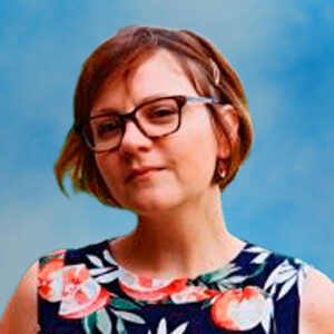 Headshot of board member Amelia Randich in floral dress and glasses