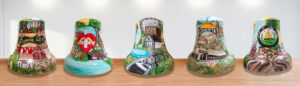 Five different hand-painted liberty bells with bright colors