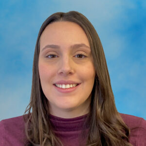 Headshot of board-certified physician assistant Cecilia Russo with long brown hair and wearing a purple top