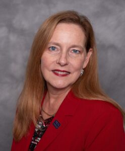 Jenn Walsh's headshot in red blazer