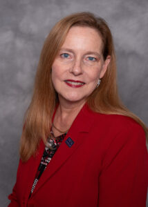 Jennifer Walsh's headshot in red blazer