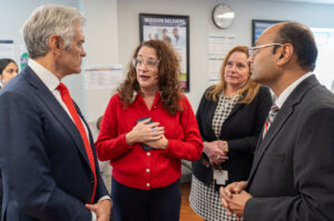 Dr Oz standing in a group talking with Dr Thomas, Jenn Walsh and Dr Sheth in a resident room