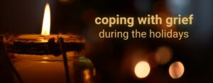 A graphic with a burning candle in the dark that says coping with grief during the holidays