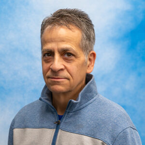 Michael Mucciolo headshot with blue sweatshirt