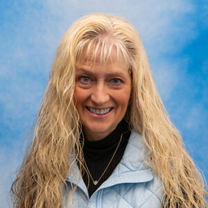 Sarah Mucciolo headshot with blue jacket and long blonde hair