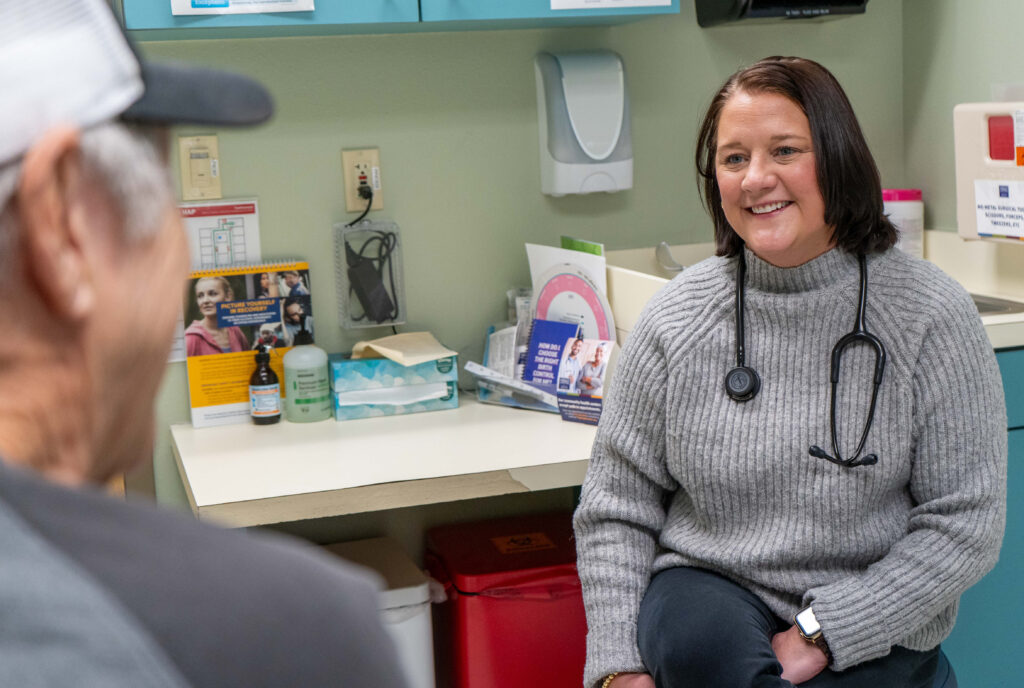 Mallory Racoski, right, a board-certified physician assistant, listens to Elmer “Butch” Richie at an appointment at The Wright Center for Community Health Tunkhannock.