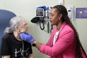 dr amatus legbedion is in a patient exam room in one of our community health centers