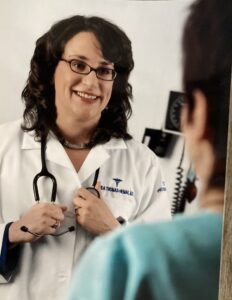 Dr. Linda Thomas-Hemak cares for a patient in 2008.