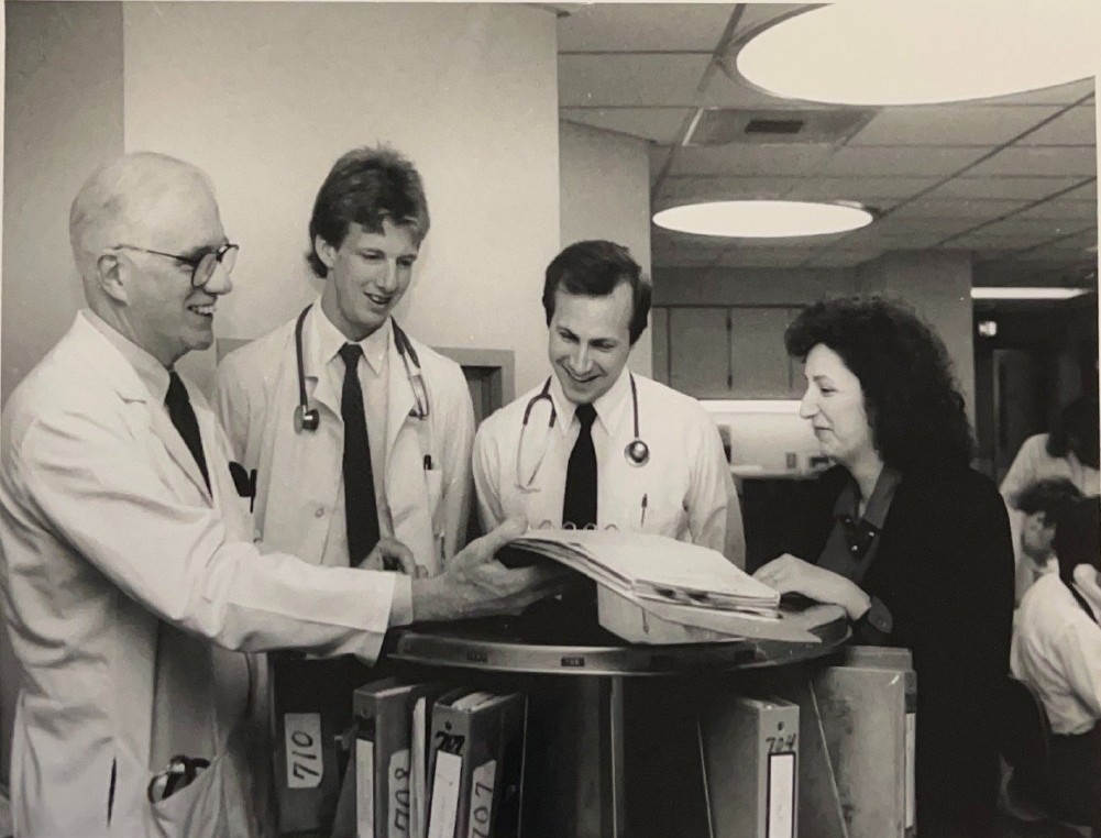 Internal Medicine residents and Dr. Robert Wright (far left) look over a patient's chart in the hospital