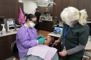 Dr. Caitlyn McCarthy, left, examines a patient at The Wright Center