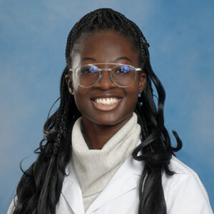 IM resident Adwoa Ansare-Konadu headshot in white coat and on blue background