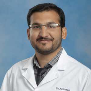 IM-Geri resident Ali Zaman headshot in white coat and on blue background
