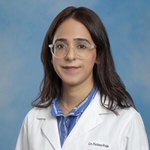 IM resident Fatima Raja headshot in white coat on blue background
