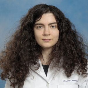 IM resident Leora Calamaro headshot in white coat and on blue background