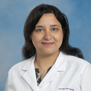 IM resident Marcelle Tawfik headshot in white coat on blue background