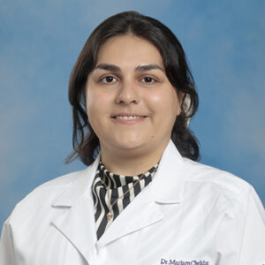 IM resident Mariam Chelidze headshot in white coat and on blue background