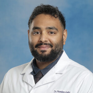 FM-Scranton resident Nandan Joshi headshot in white coat and on blue background