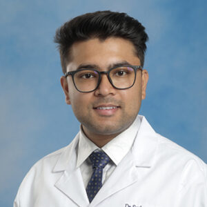 FM-Ohio resident Sushant Guragain headshot in white coat and on blue background