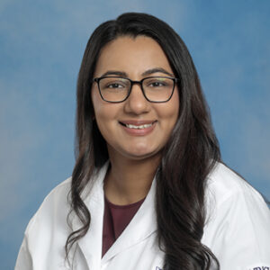 IM resident Wafa Shakil headshot in white coat on blue background