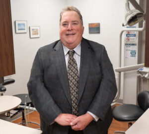 Portrait of Dr. Frank Pagano wearing a gray suit.