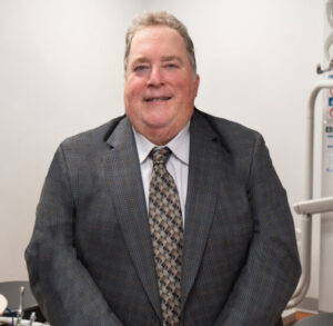 Portrait of Dr. Frank Pagano wearing a gray suit.