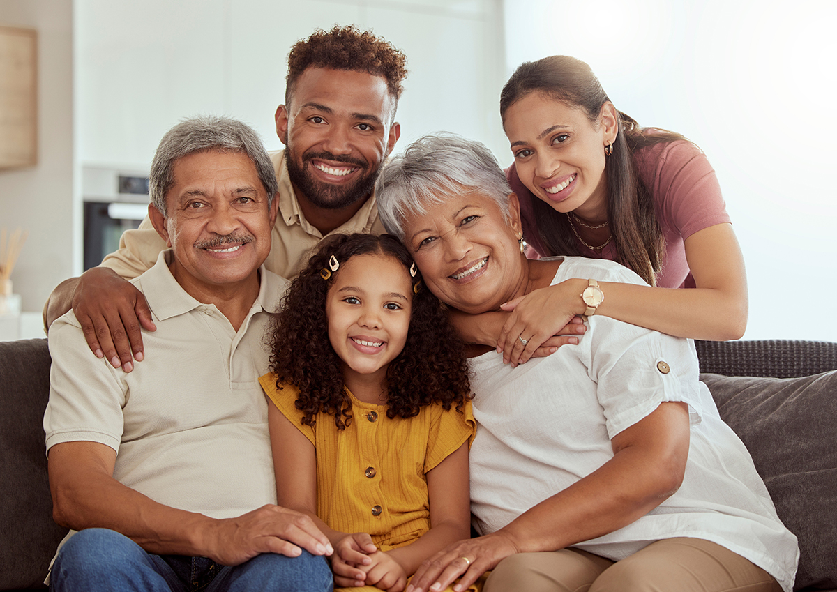 Portrait of big family on a sofa in the living room.