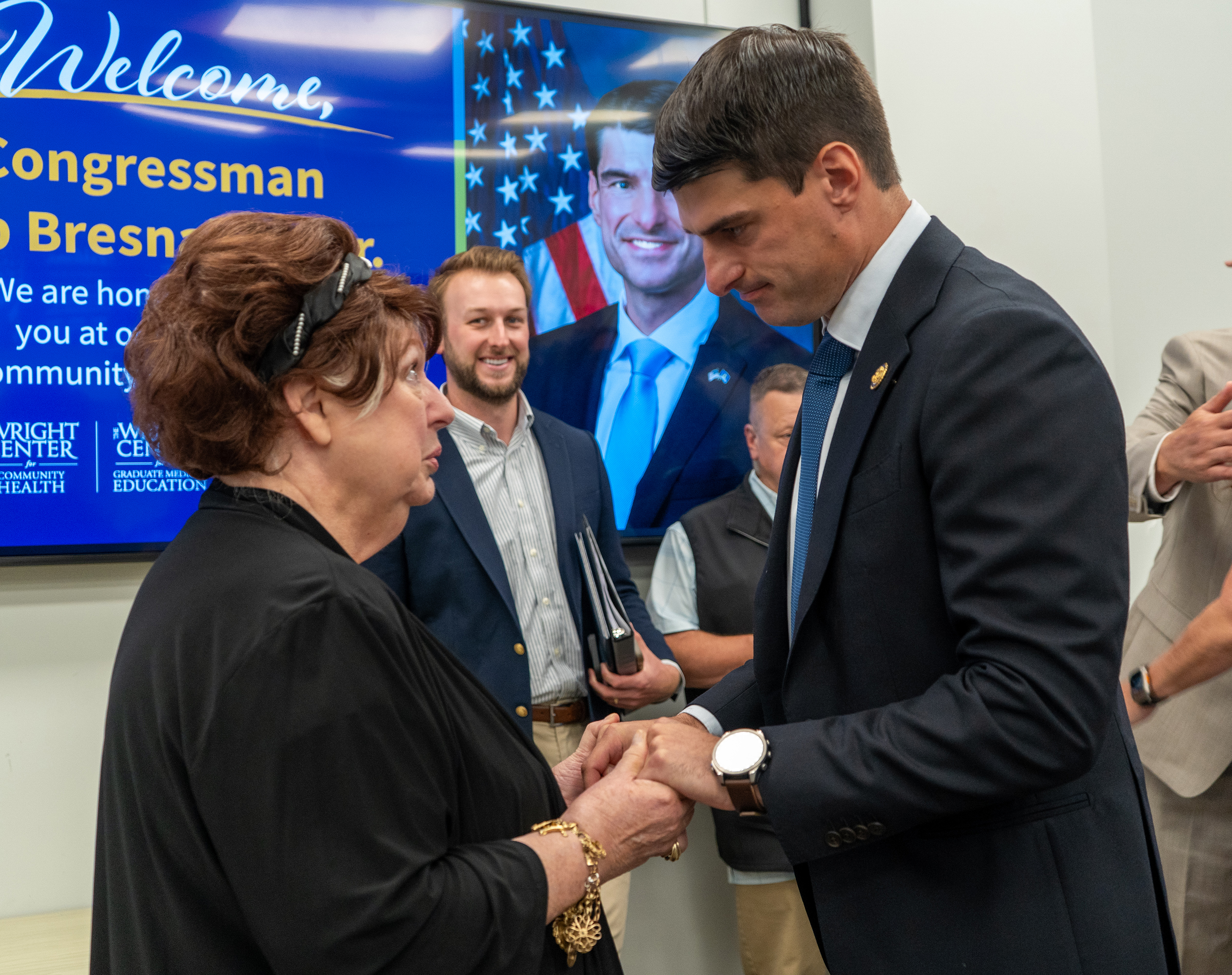 U.S. Representative Rob Bresnahan Jr., right, greets Mary Marrara, secretary and chair of The Wright Centers for Community Health and Patient & Community Engagement Boards of Directors, before the start of the press conference.