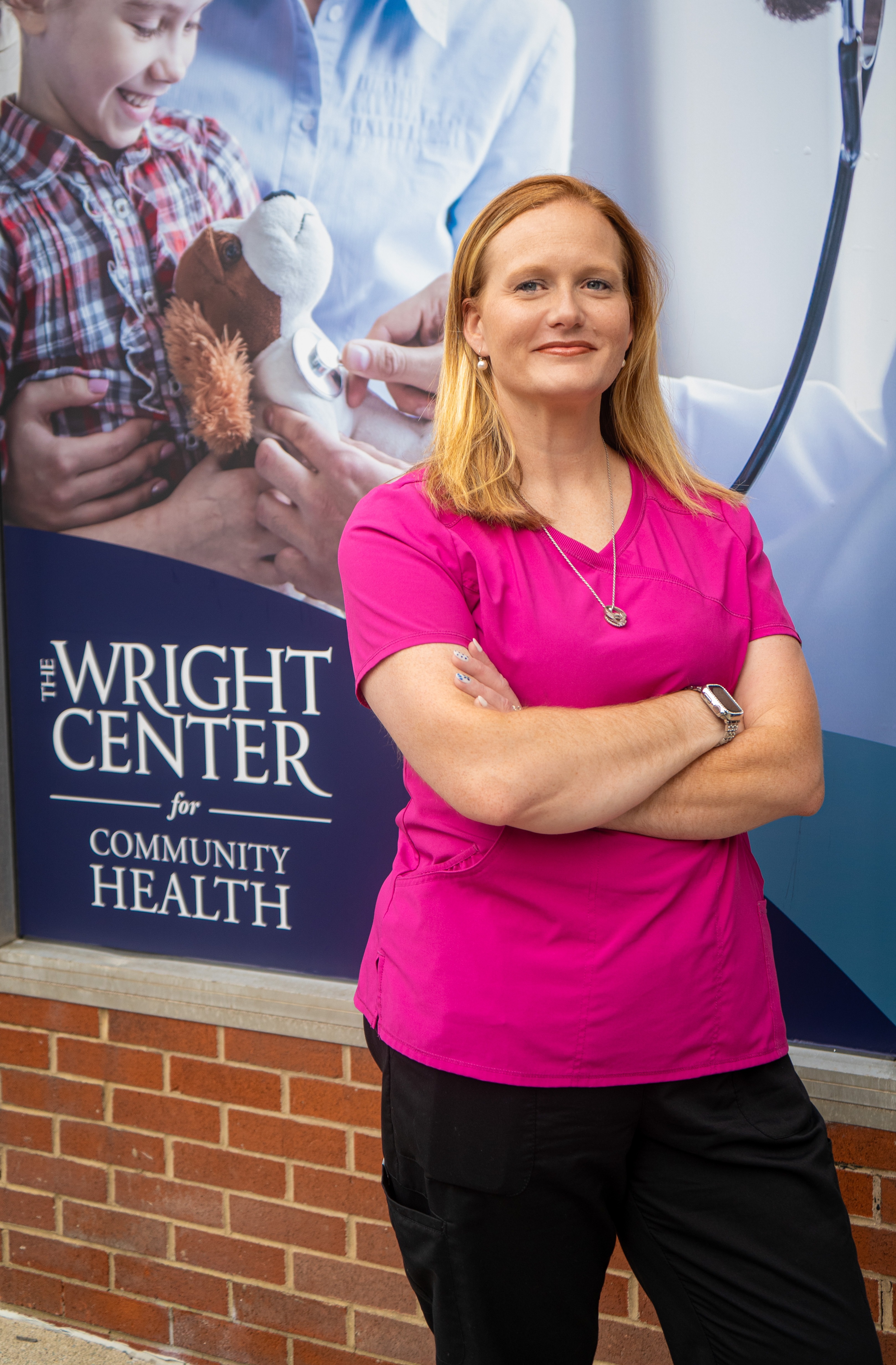 Antoinette “April” Savage-Mushow in front of The Wright Center for Community Health Friendship House – Carbondale, where she works as the site coordinator and clinical administrative assistant.