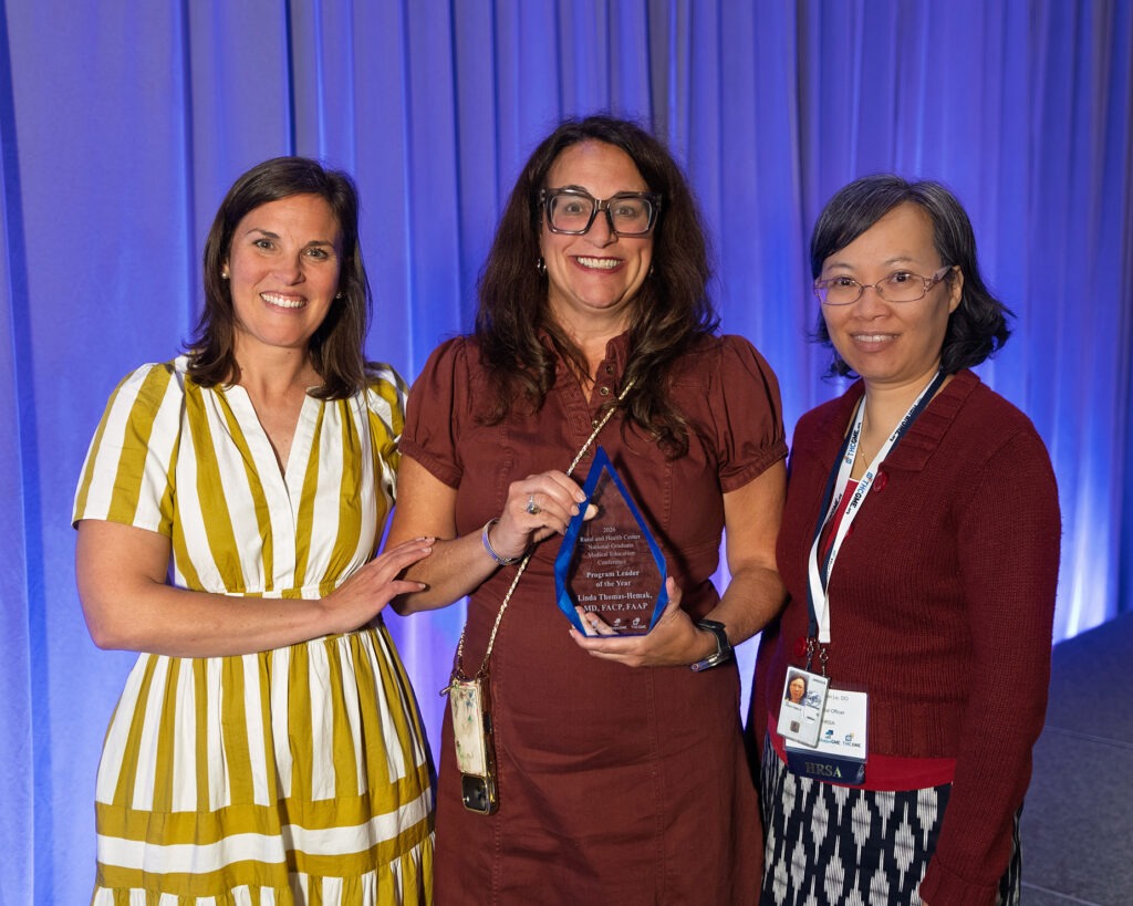 Dr. Linda Thomas-Hemak, president and CEO of The Wright Centers for Community Health and Graduate Medical Education, center, accepts the inaugural 2026 Program Leader of the Year Award from the Cecil G. Sheps Center for Health Services Research’s ShepsGME Technical Assistance Center during the Rural and Health Center National Graduate Medical Education Conference.